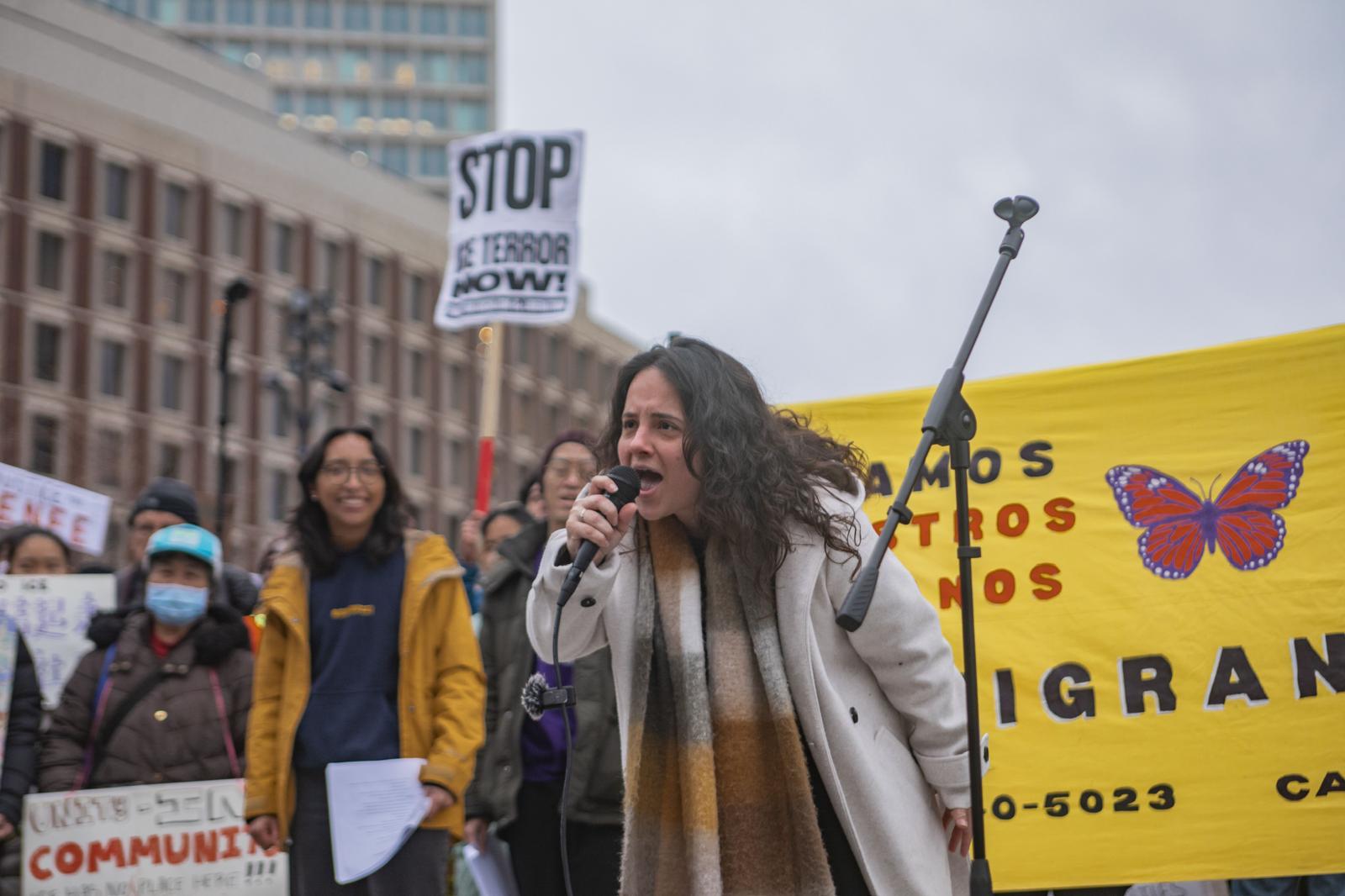 Woman speaking into the microphone at an immigrant rights rally